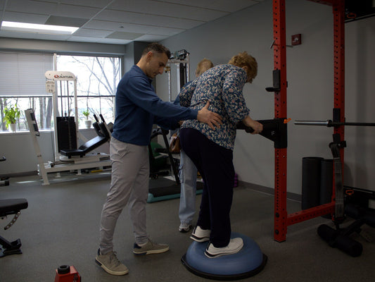 Dr. Rob Letizia guiding a balance exercise on a BOSU at Spectrum Therapeutics in Wayne, NJ.