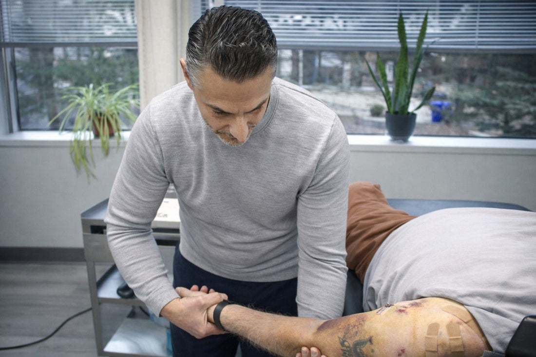 Patient performing rotator cuff exercises with physical therapist at Spectrum Therapeutics Wayne NJ post-surgical rehabilitation clinic