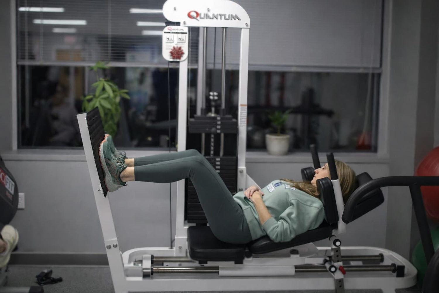 Patient performing hip strengthening exercise on leg press machine in Wayne NJ physical therapy clinic