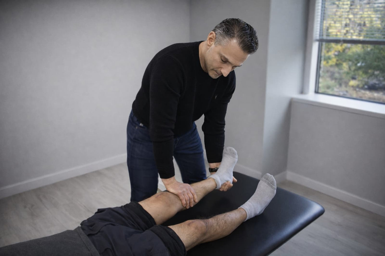 Physical therapist performing orthopedic manual physical therapy for a patient with knee pain after total knee replacement in Wayne, NJ.