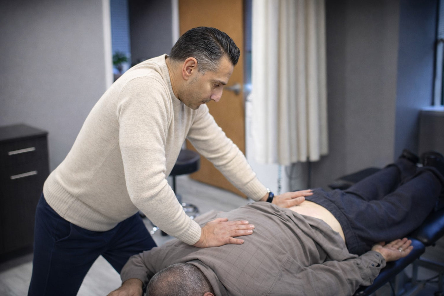 Physical therapist providing low back pain treatment in Wayne NJ clinic setting